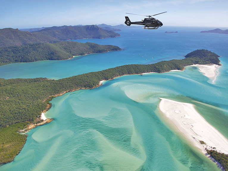 Helicopter flying over islands