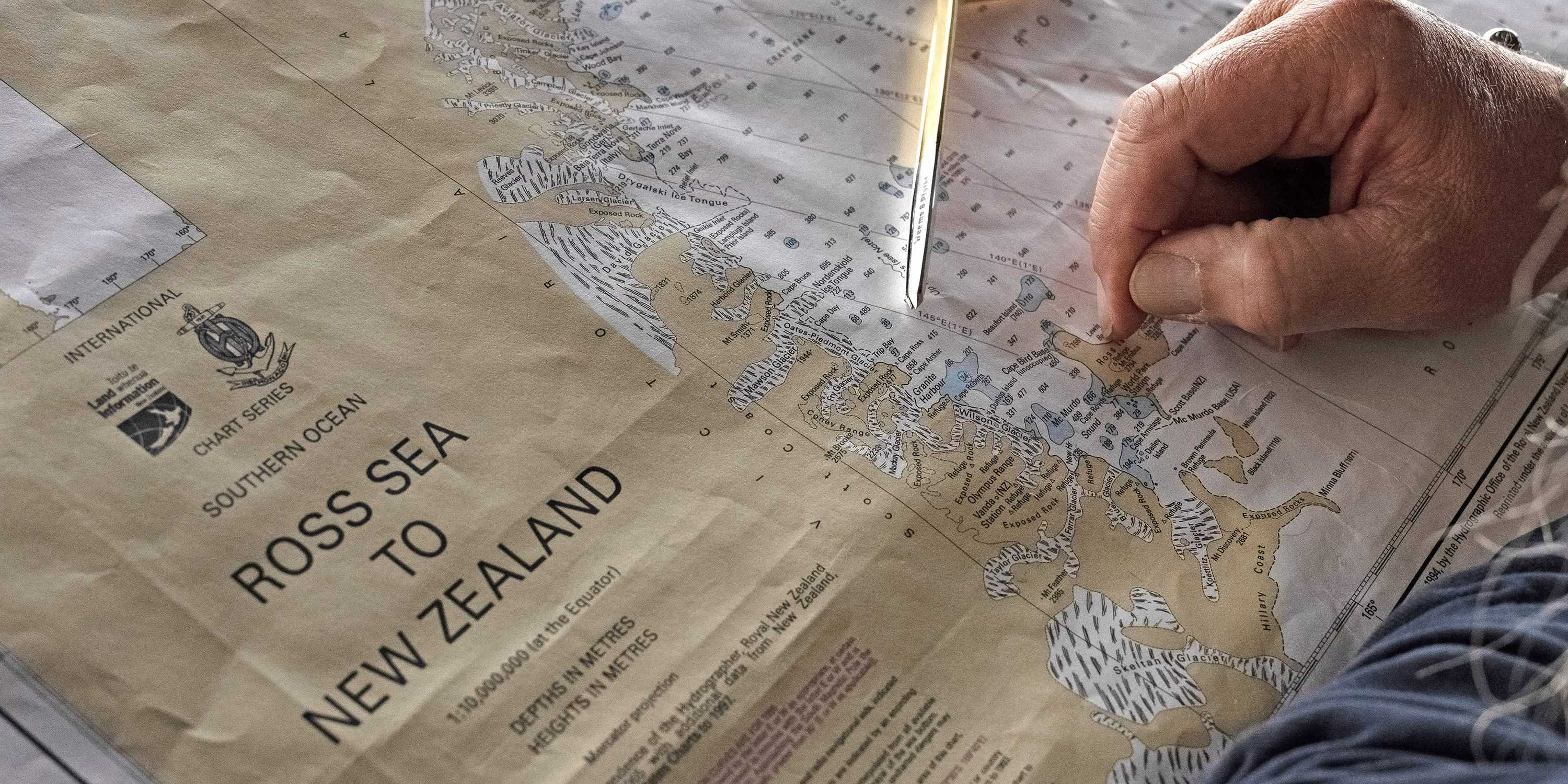 Explorers looking at map of East Antarctica