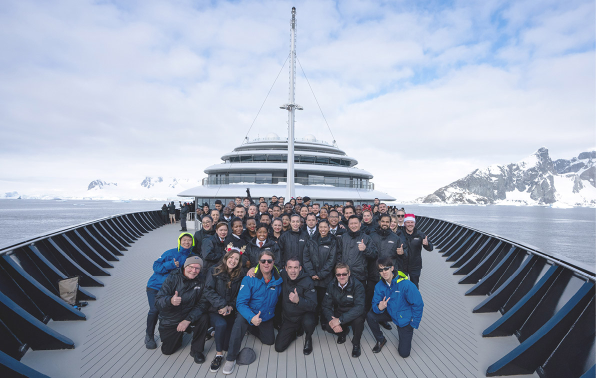 group shot of the crew on the deck of the ultra-luxury cruise ship "Scenic Eclipse II" in Antarctica