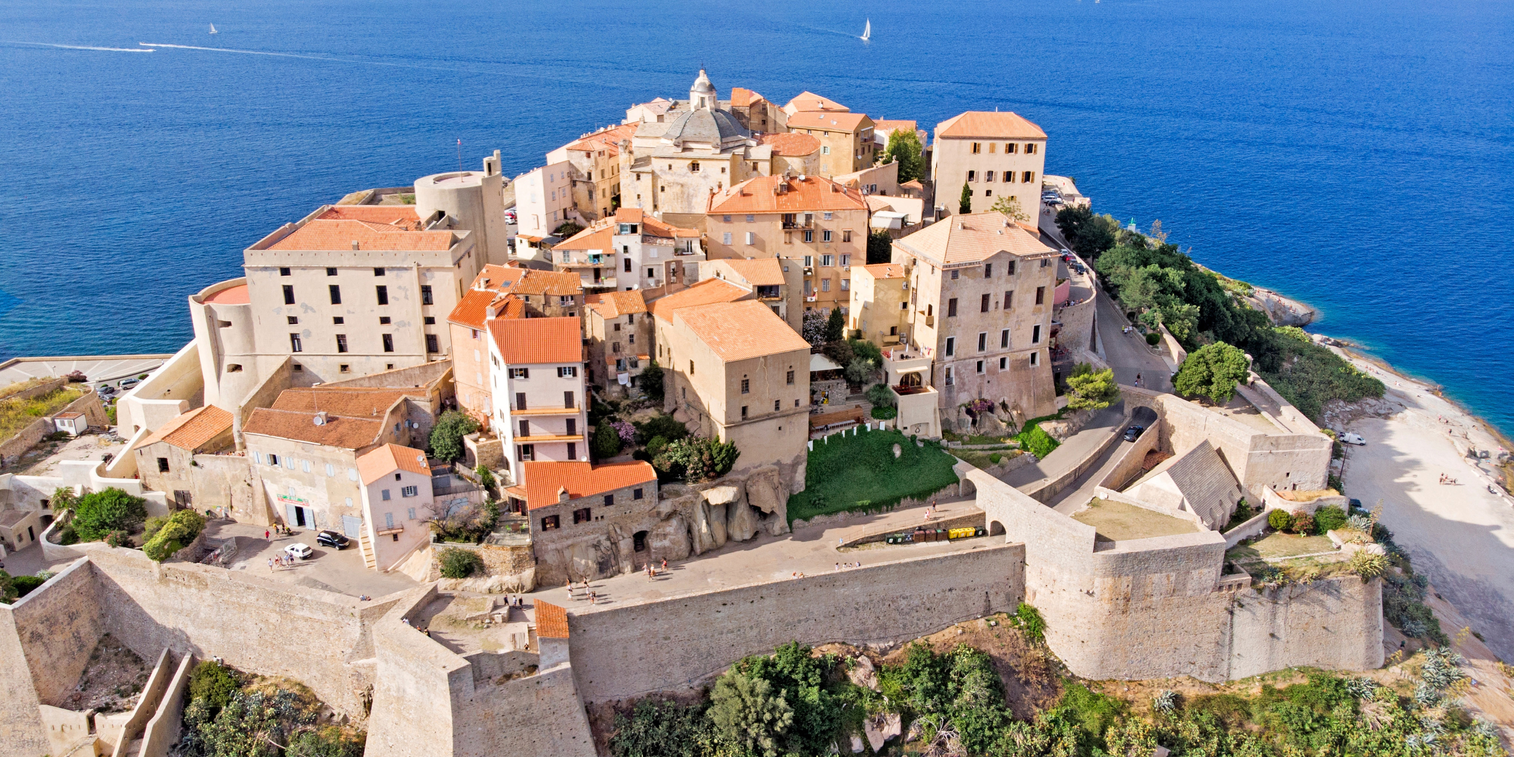 Arial view of a french coastline with european buildings against calm blue waters 