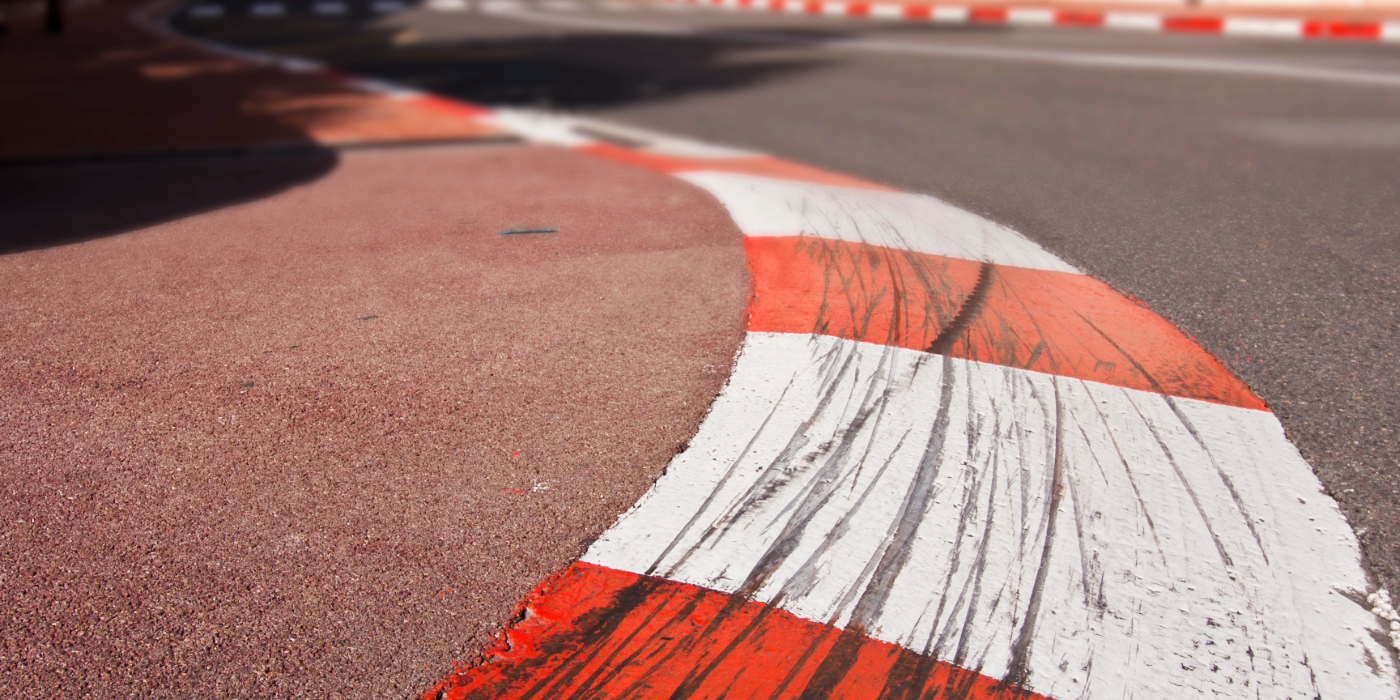 The edge of a race track with tyre marks